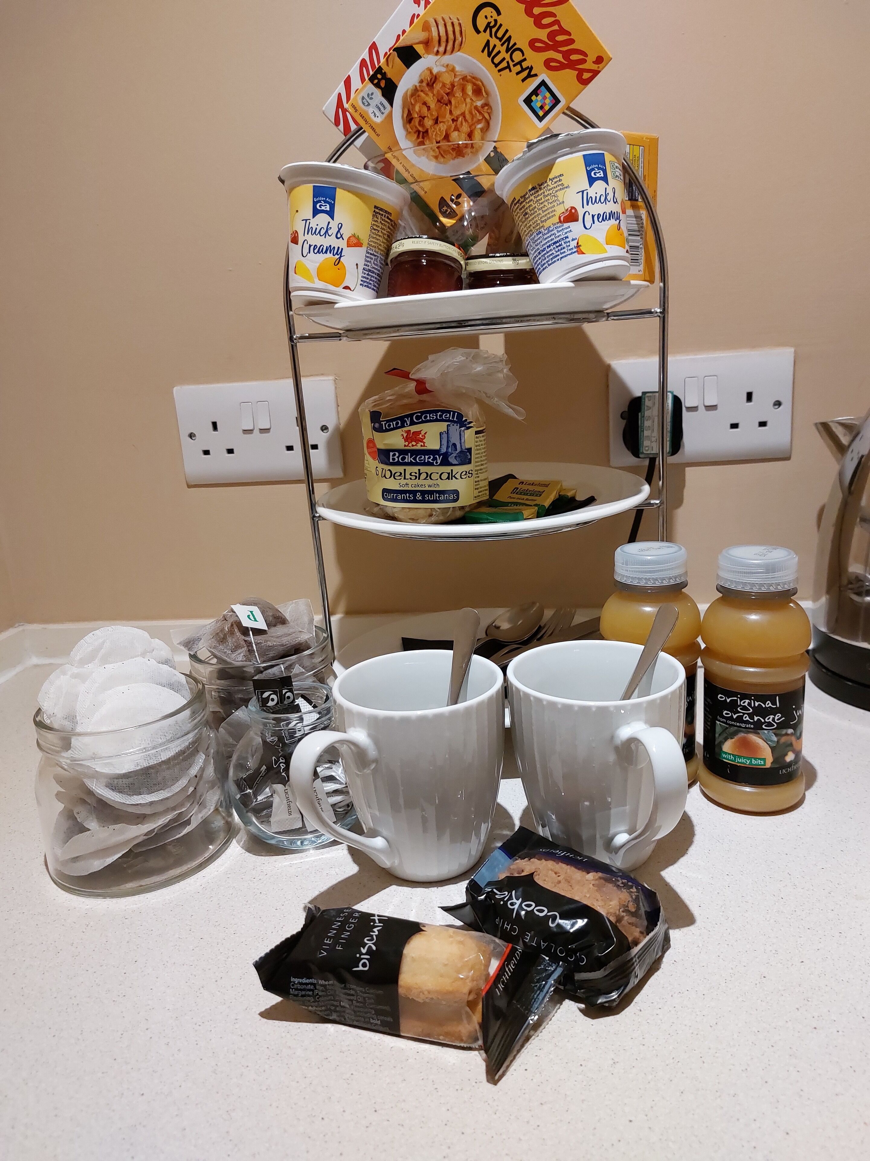 A kitchen counter with a variety of food items and kitchenware.