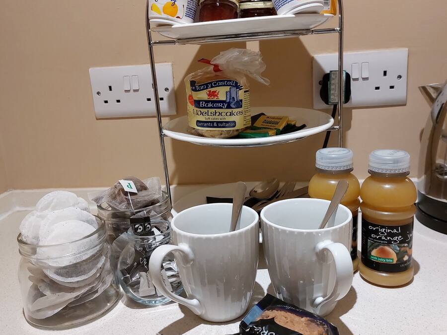 A kitchen counter with a variety of food items and kitchenware.