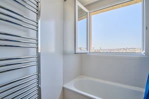 Bathtub, hair dryer, towels, shampoo