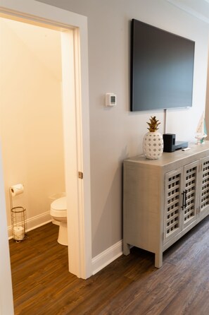 Enjoy a refreshing bathroom retreat with a bathtub, toilet, and flat-screen TV.