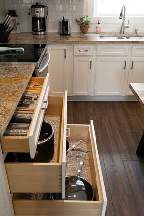 Efficient kitchen with oven, coffee maker, toaster, and sink for convenient meal preparation.