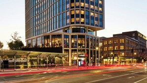 A modern building with a curved facade, large windows, and a glass entrance.