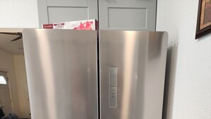 A stainless steel double-door refrigerator in a kitchen with a wooden floor and a white wall. - Fishermen & Hunter's Paradise, Pet Friendly. Close to boat launches
 (Rufus)
