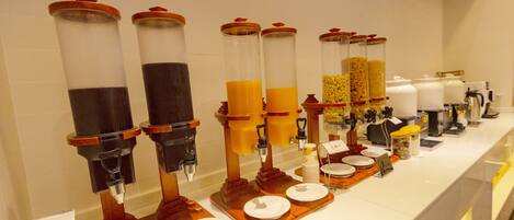 A beverage station with multiple dispensers and serving trays.