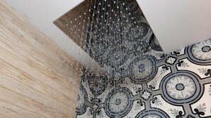 A close-up of a patterned tile floor with a water feature above it. - King's rooftop suites  (Tel Aviv)