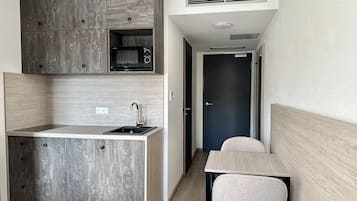 Studio Apartment with Kitchen | Private kitchen | Full-size fridge, microwave, stovetop, cookware/dishes/utensils