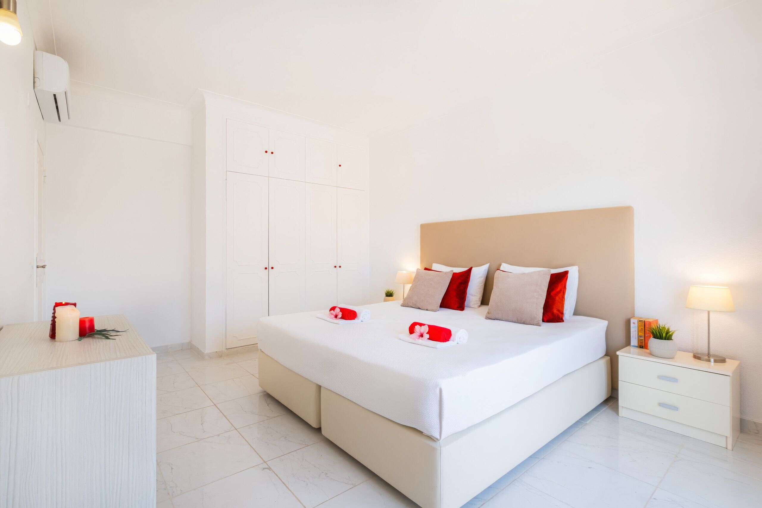 Ein Hotelzimmer mit Bett, Nachttischen, einem Kleiderschrank und einem Badezimmer.