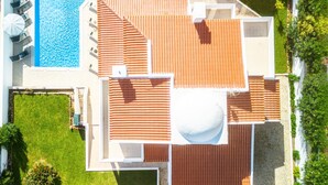 A rooftop terrace with a swimming pool, a covered seating area, and a landscaped garden. - Comfort and fun with heatable pool and BBQ (Albufeira)