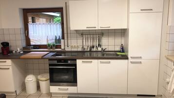 Fridge, stovetop, dishwasher, coffee/tea maker