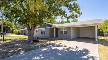 Situated in a peaceful neighborhood, this single-story home features a covered porch and a garage.