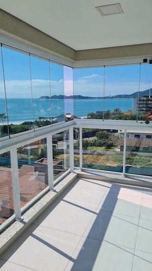 Enjoy expansive sea views from this balcony with a modern aesthetic.