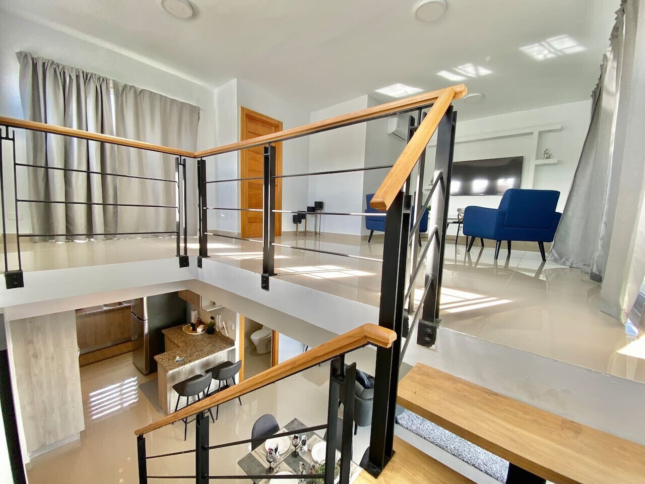 A multi-level living space with a kitchen, dining area, and seating area.