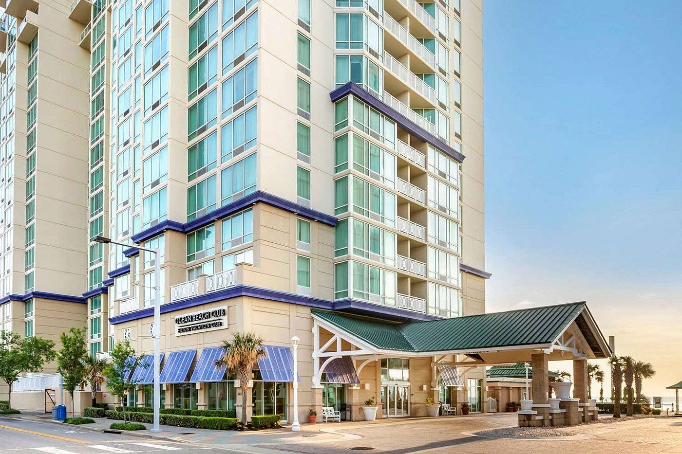 A multi-story hotel with a prominent entrance and a covered outdoor area.