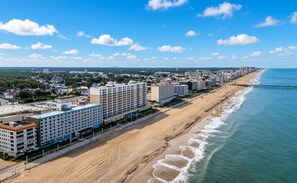 A coastal hotel with multiple floors, a beach promenade, and a pier extending into the ocean. - Diamond Resorts Ocean Beach Club - 1 Bedroom Accessible No Roll-in Shower City View (Virginia Beach)