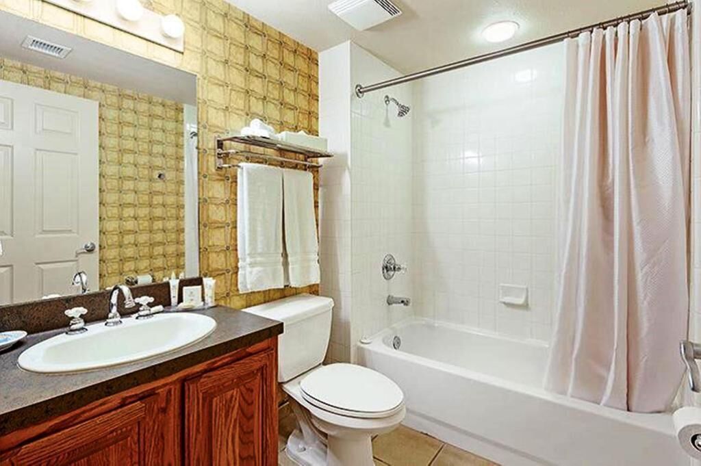 A bathroom with a sink, toilet, and bathtub.