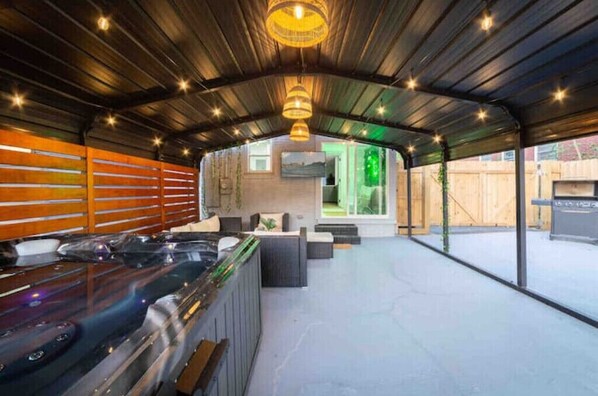 Relax in a serene, enclosed outdoor space with a hot tub and unobstructed views.