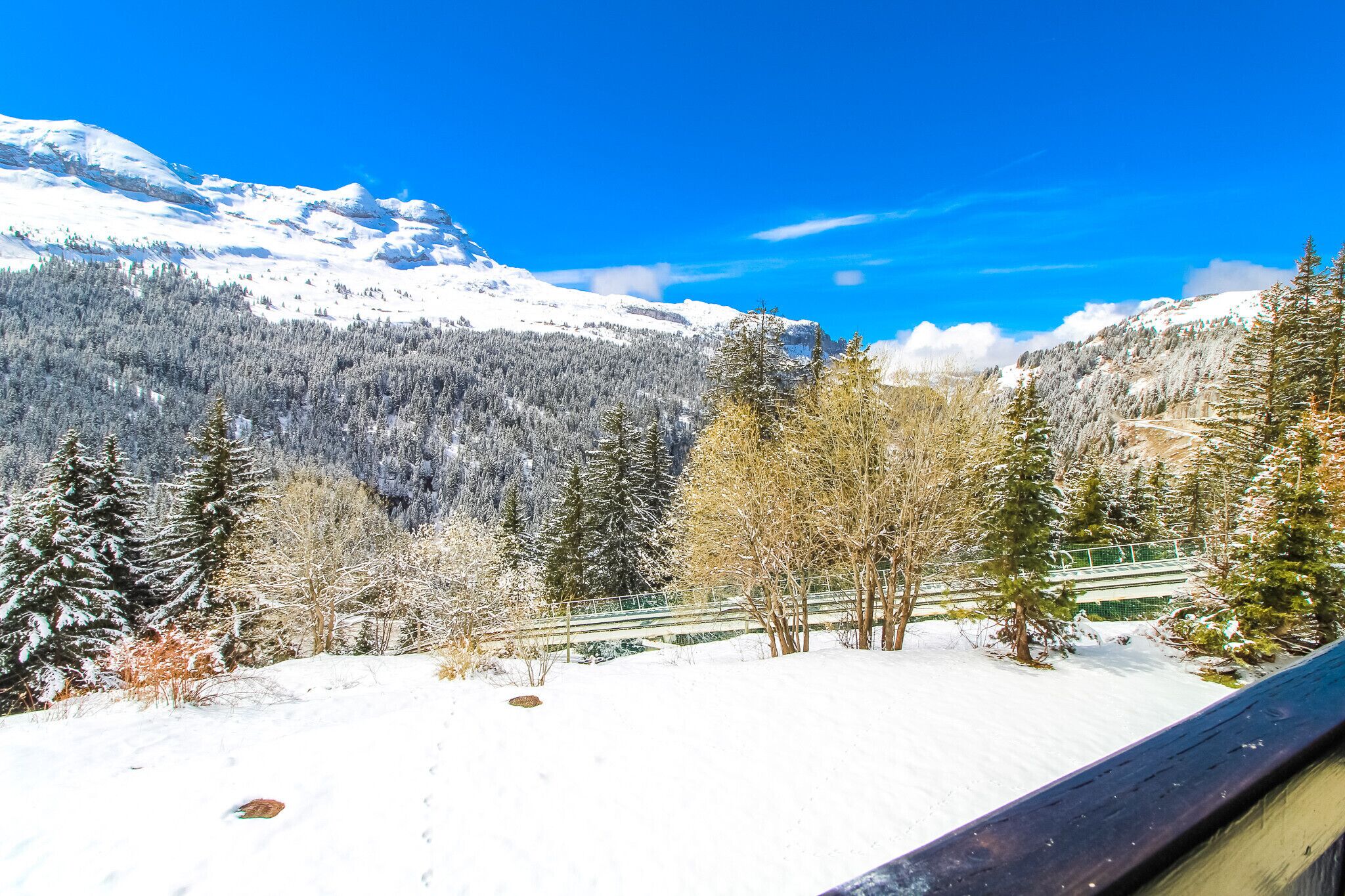 A snowy mountain landscape with a clear blue sky.