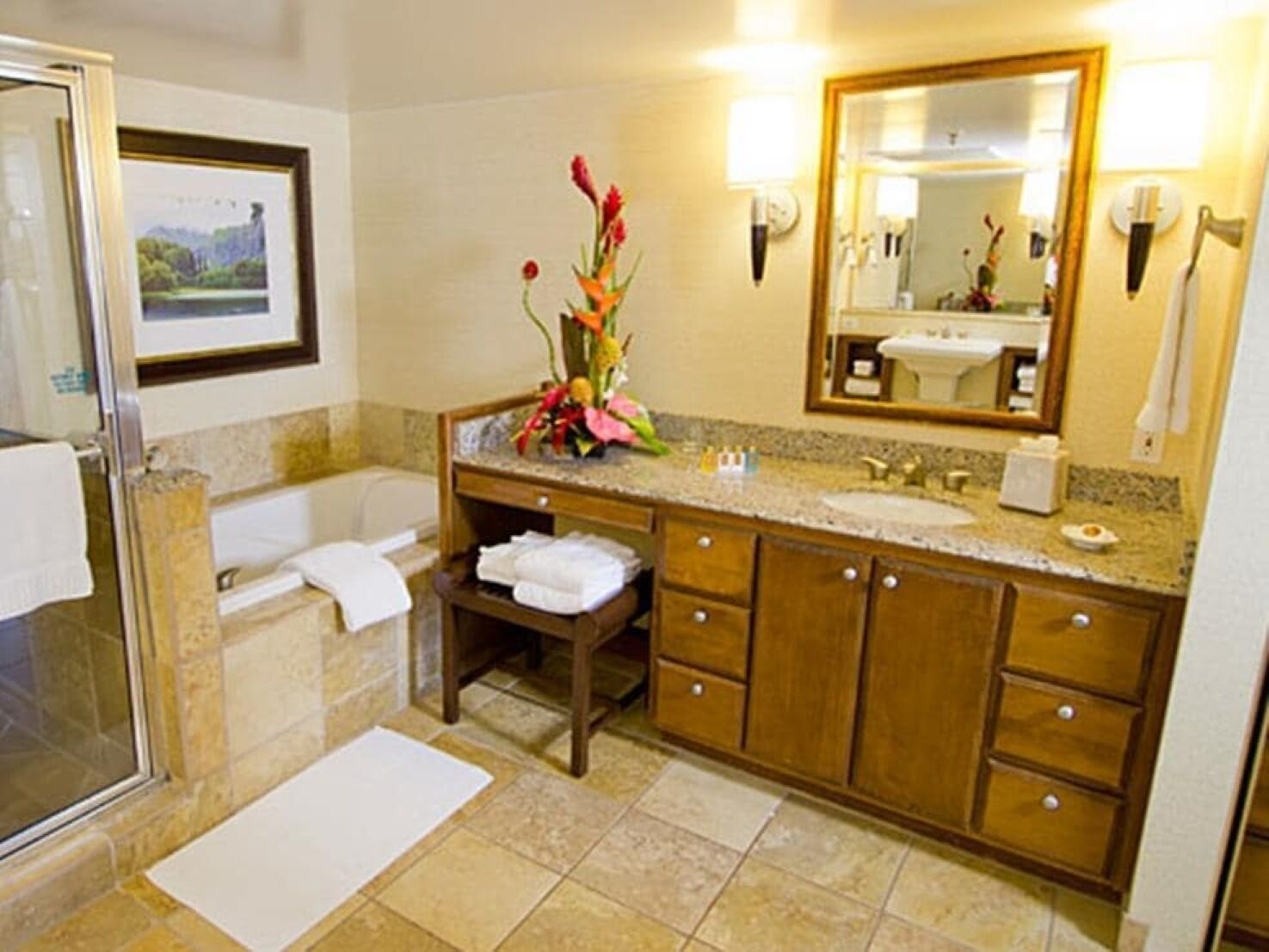 A bathroom with a bathtub, a sink, a mirror, and a shower.