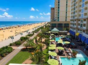 A resort with a pool area, beach access, and a view of the ocean.