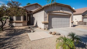 A residential house with a garage, a driveway, and a small garden area with a palm tree. - Poolside Paradise Terramar Family Safe Retreat Beautiful Northwest Peoria (Peoria)