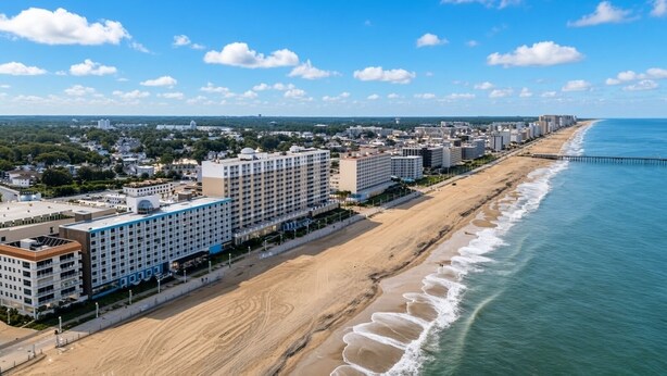 A coastal hotel with multiple floors, a beach promenade, and a pier extending into the ocean.