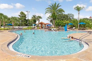 A swimming pool with a 3ft depth and 0.9m width, surrounded by palm trees and lounge chairs.