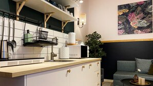 A modern kitchen with white cabinets, a wooden countertop, and a built-in microwave. - Apartment for 4 guests, Wawel & Old Town Krakow II, św. Gertrudy (Kraków)
