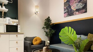 A modern living room with a grey sofa, a small round coffee table, and a white cabinet. - Apartment for 4 guests, Wawel & Old Town Krakow II, św. Gertrudy (Kraków)