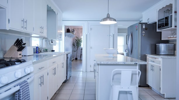 A modern kitchen with white cabinetry, stainless steel appliances, and a central island. - Riverside Getaway! Minutes to Downtown Woodstock (Woodstock)