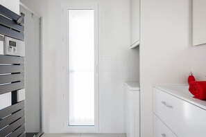 A modern bathroom with a toilet, a sink, and a mirror. - Stroll to Beach from Sea-View Penthouse with AC (Antibes)