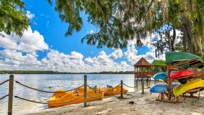 A beach with kayaks and a wooden structure. - Grand Beach - 3 Bedroom Full Mobility - Phase I (Orlando)