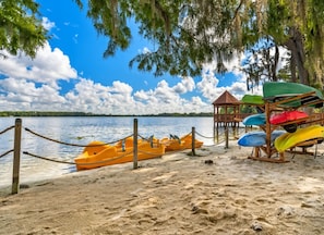 A beach with kayaks and a wooden structure. - Grand Beach - 3 Bedroom Full Mobility - Phase I (Orlando)