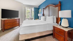A hotel room with a large bed, a TV, a desk with a lamp, and a view of the outdoors. - Orlando | Family Orlando Park Getaway | Pool + Hot Tub | 2BR Condo (Orlando)