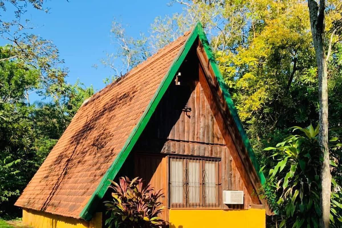A small, single-story building with a sloped roof and a green trim.