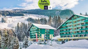 A hotel with multiple floors, a restaurant, and a reception area. - Schladming | Family Alps Stay | Pool + Spa | 2BR Condo (Schladming)
