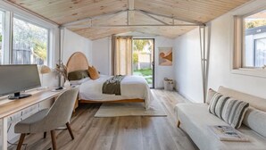 A bedroom with a bed, desk, chair, and a window. - Sol Coastal Retreat - Outdoor Spa and Sauna (Rosebud)