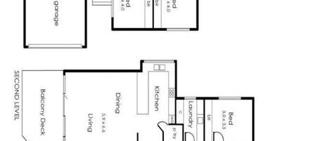 A floor plan of a residential property with a double garage, a balcony deck, a family room, a dining area, a kitchen, a living room, a bathroom, and a shed.