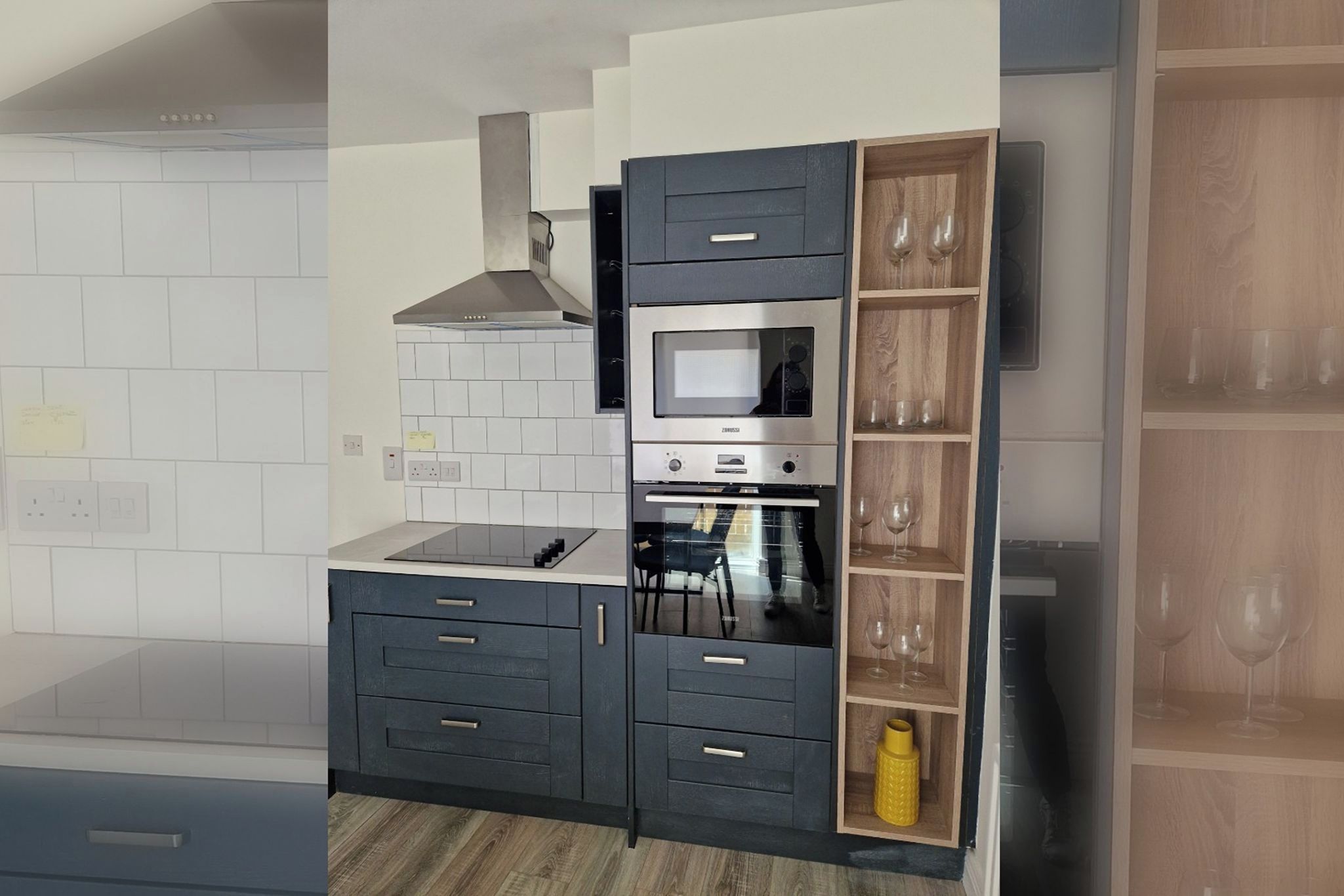A kitchen with a built-in microwave, oven, and a wooden wine rack.