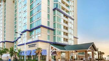 A multi-story hotel with a prominent entrance and a covered outdoor area.