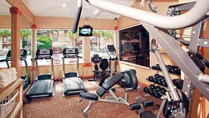 A gym with treadmills, elliptical machines, and weight equipment.