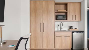 A modern kitchen with wooden cabinets, a microwave, a sink, and a dishwasher.