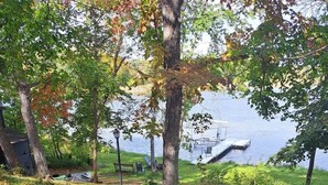 A stone pathway leading to a dock by a lake, surrounded by trees and greenery. - Island View McDonald Lake (Dent)