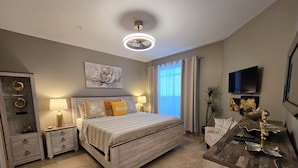 A bedroom with a bed, bedside tables, a dresser, a TV, and a window with curtains. - Clearwater Condo w/Pool Access, 4Mi to Beach! (Clearwater)