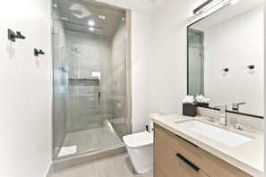 Shower, designer toiletries, hair dryer