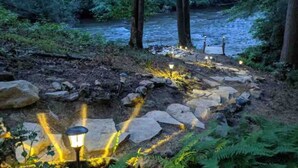 A stone pathway leading to a river with lights along the path. - Fun on the River - Swim, Fish, Hike Near Tubing (Blue Ridge)