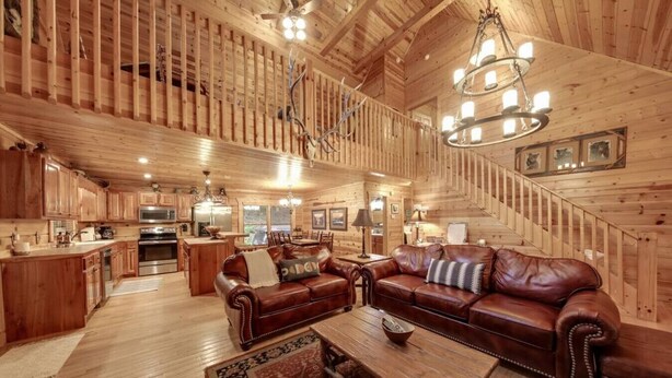A spacious log cabin interior with a large living area, a dining area, and a kitchen. - Toccoa River Fun + Hot Tub, Game Rm, Fish, Swim (Blue Ridge)