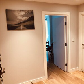 Stunning hallway leading to a dining area with a table and chairs.