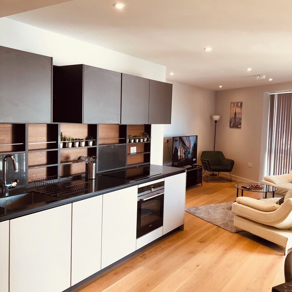 Enjoy a stylish living space with a sleek kitchen, dining area, and comfortable seating.