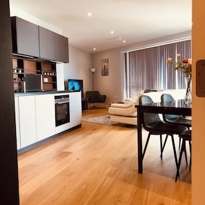 Enjoy meals at the dining table, relax in the comfortable seating area, and cook in the well-equipped kitchen.