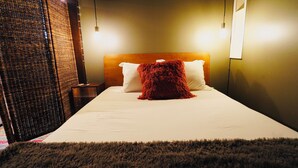 A neatly made bed with white linens and a red throw blanket, a wooden headboard, and two bedside lamps. - Walk to Music, Cafe, Bars, Food & Hospital in Central Denver. Turo + 420 ok!  (Denver)
